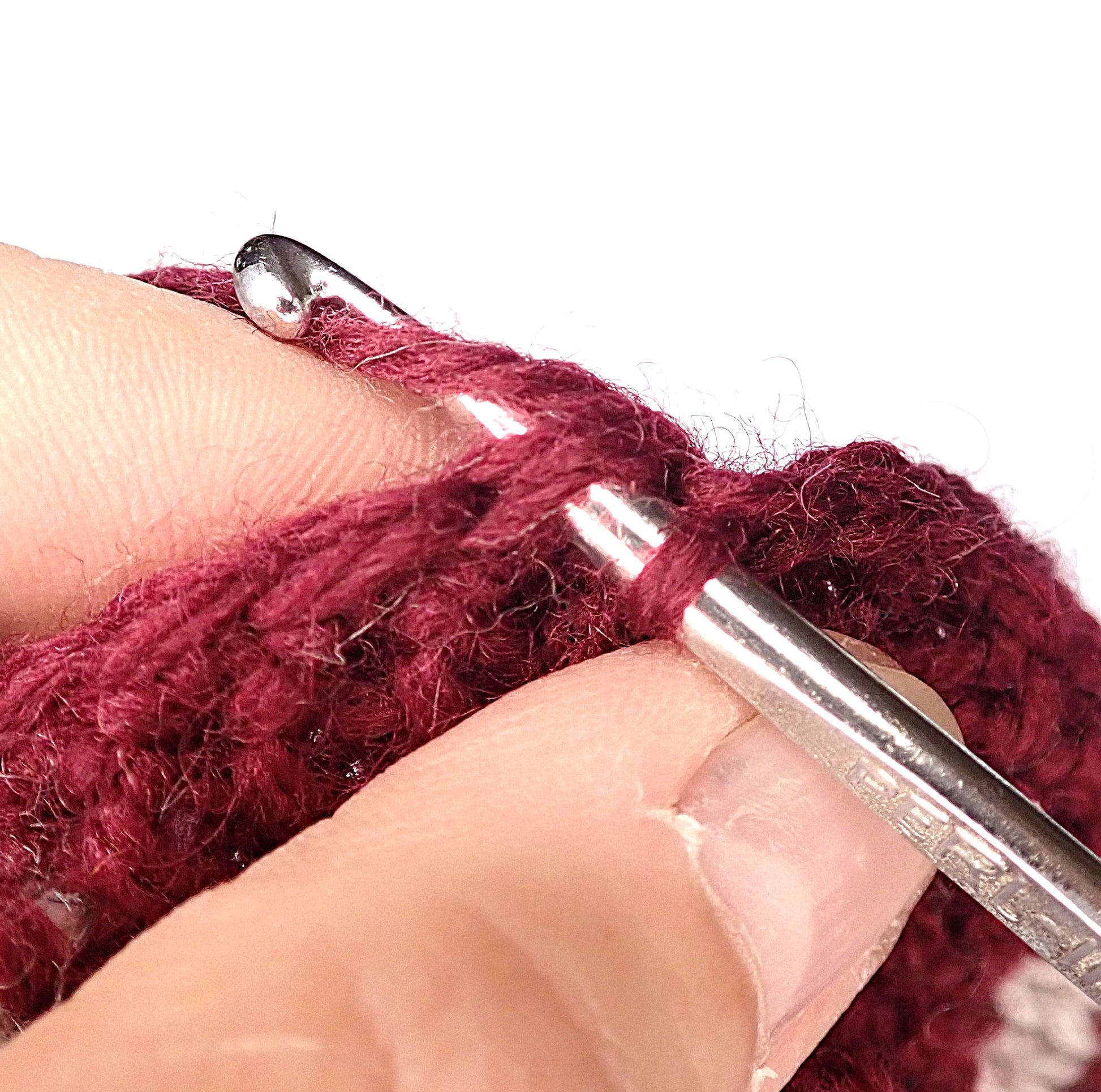 Viinipunaisesta langasta virkataan tossuun reunusta.